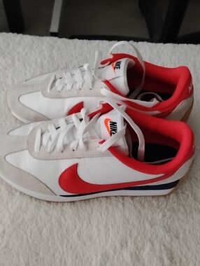 Nike Retro Style White Sneakers with Red Swoosh and Red Collar.